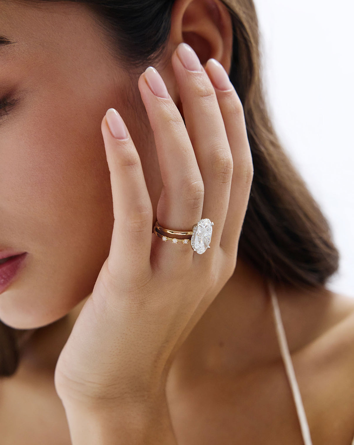 on-model image of wedding band with oval engagement ring GLOBAL