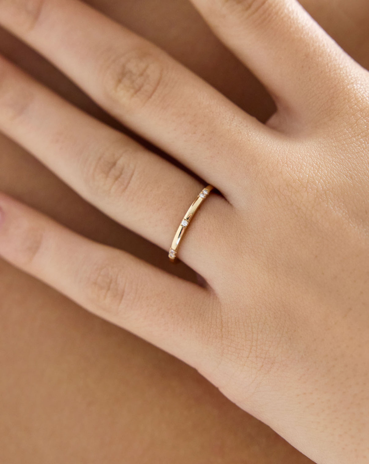 Close up view of model wearing Scattered Diamond Wedding Band GLOBAL