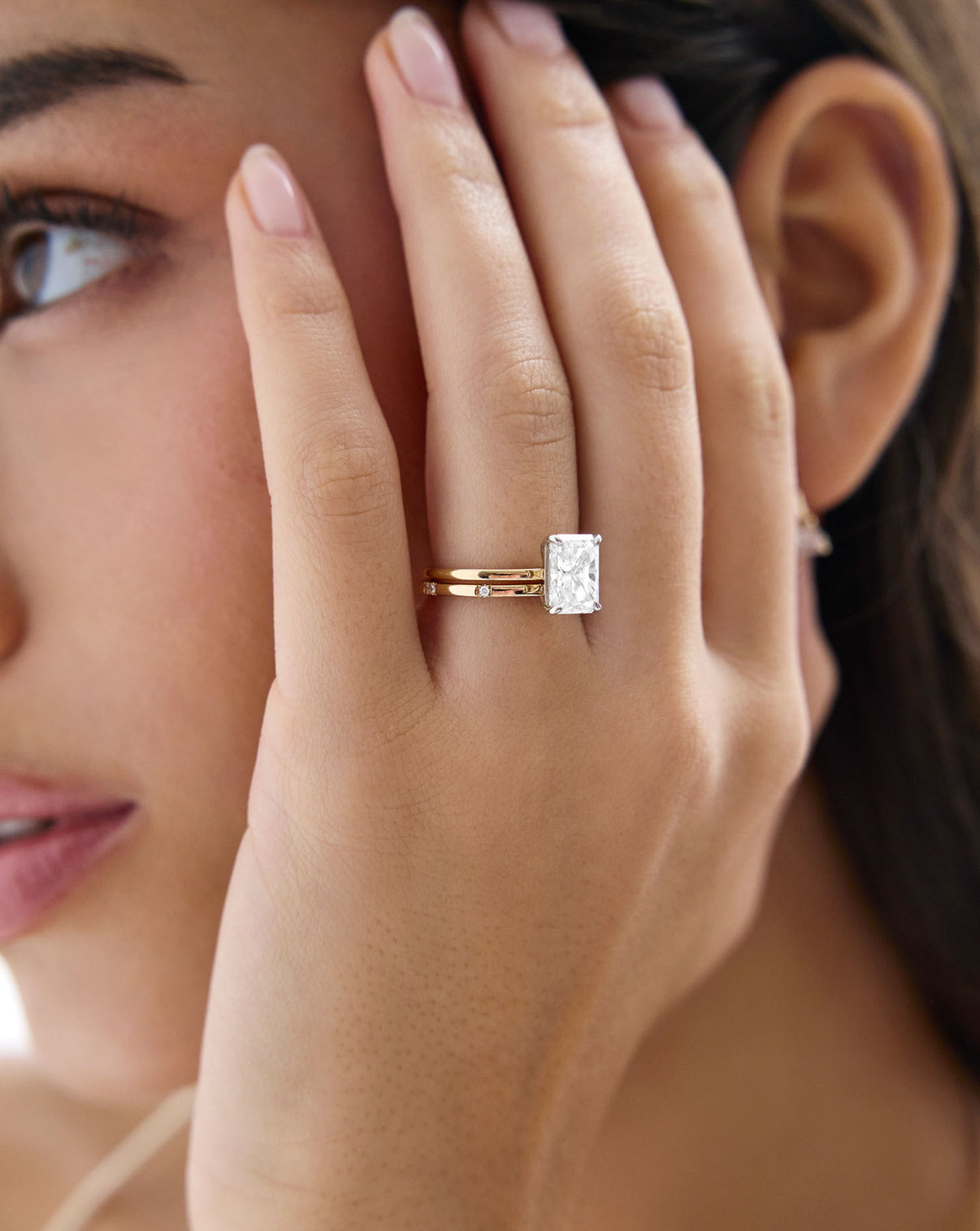 Close up view of model wearing Scattered Diamond Wedding Band stacked with diamond ring GLOBAL