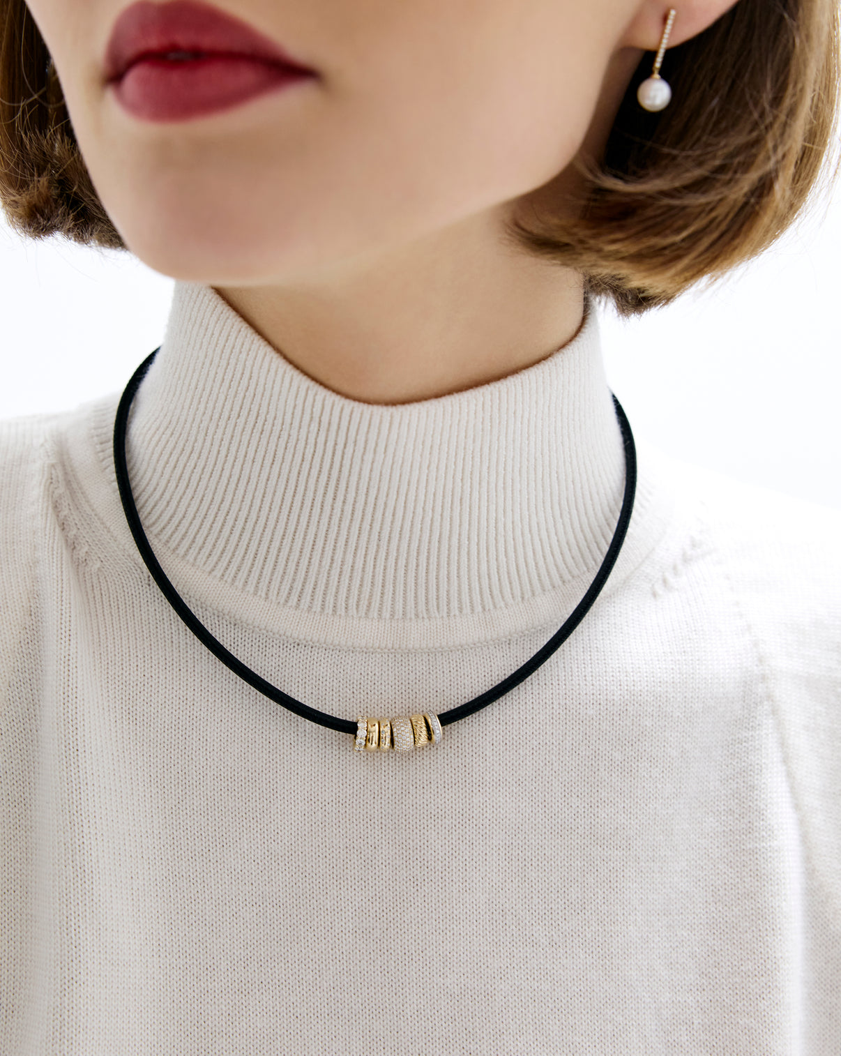 Close up of model wearing leather cord necklace.