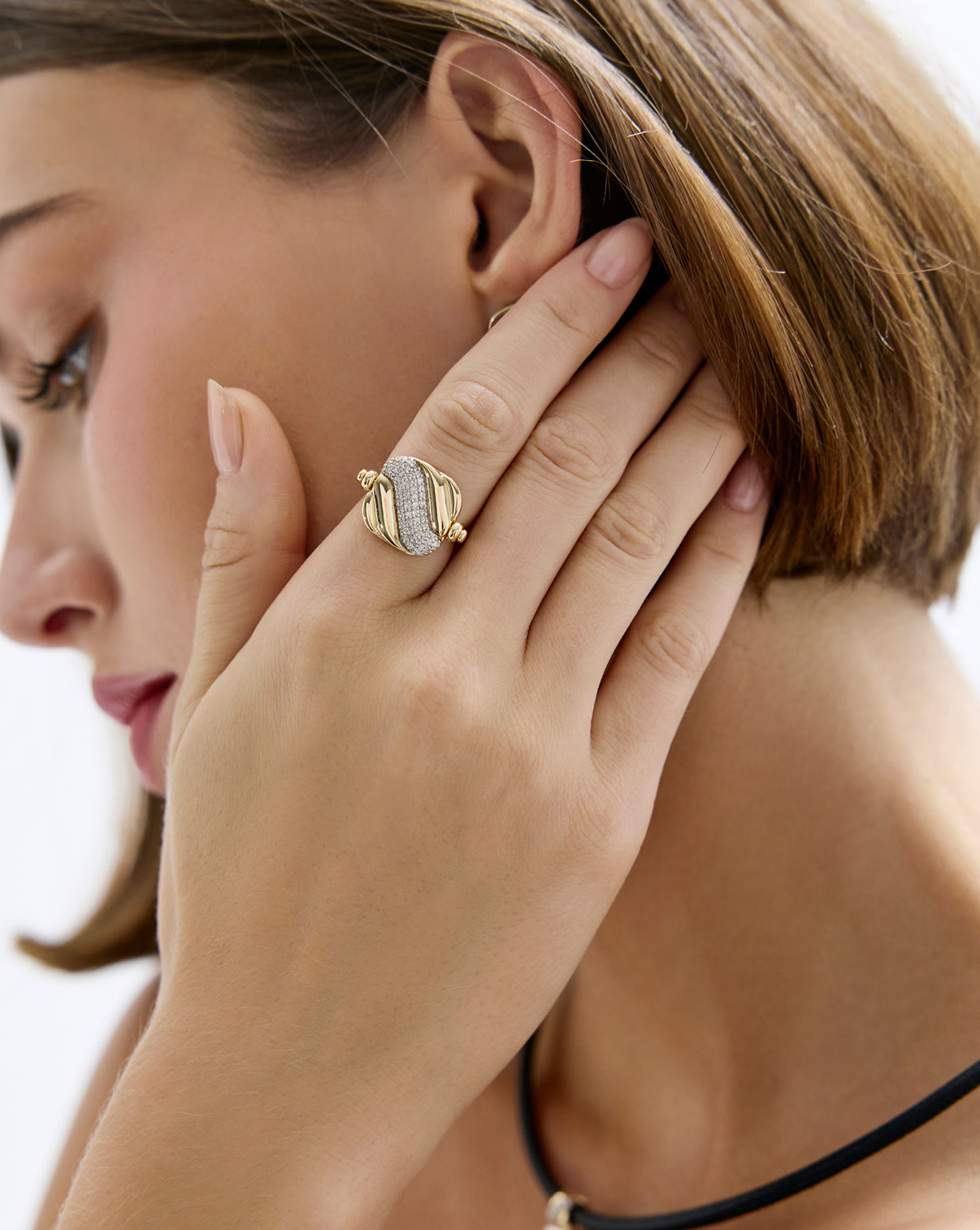 Model wearing swivel pearl + pavé ring showcasing glittering pavé side featuring 57 round natural diamonds.