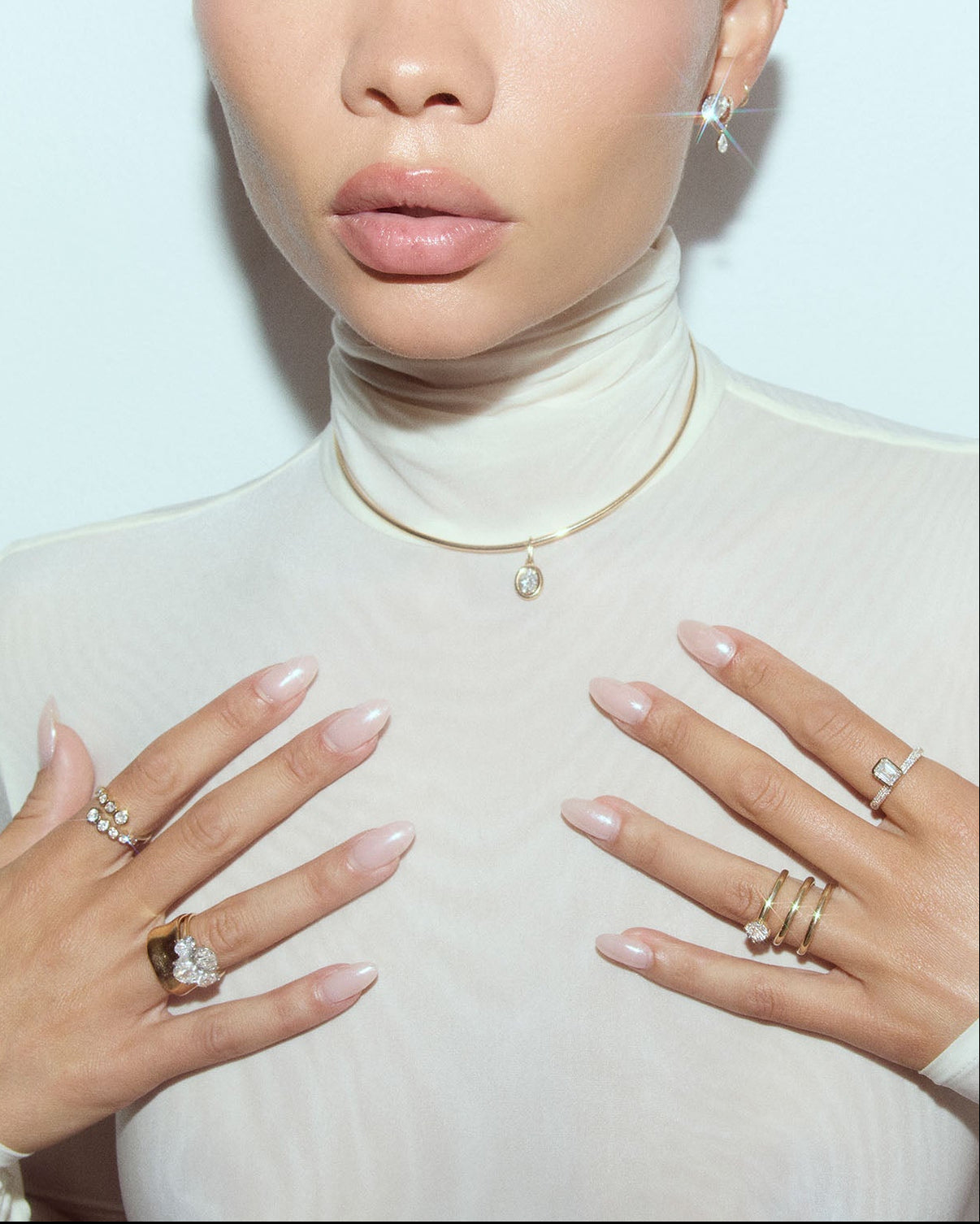 Person wearing multiple rings on a light background global