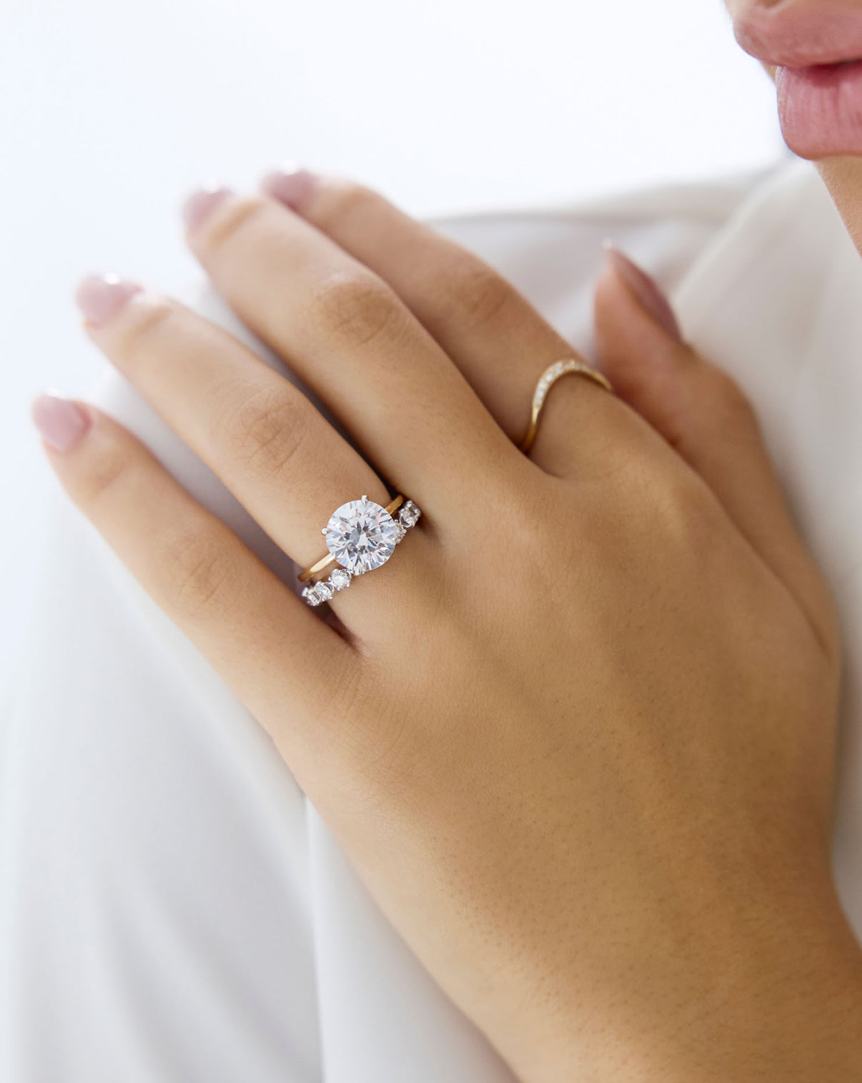 Alternate view of model wearing pave band in white Gold with other rings GLOBAL