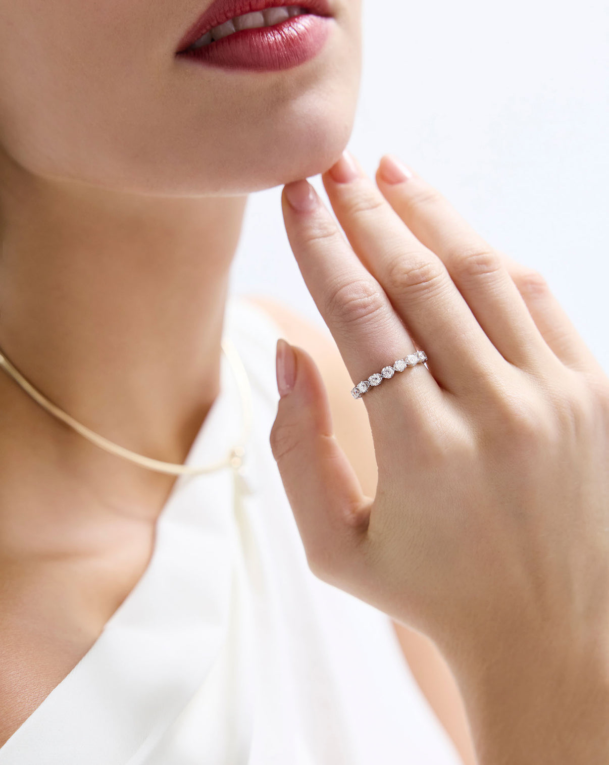 Close up of model wearing diamond pave band in white Gold GLOBAL