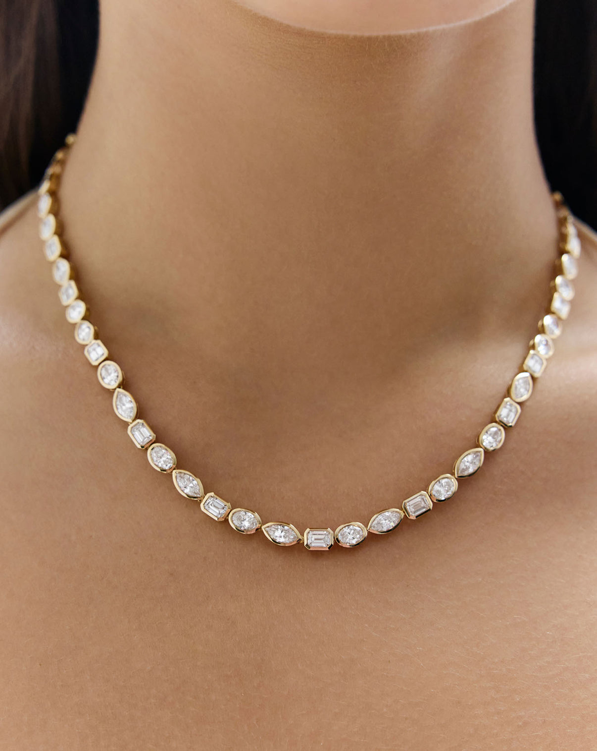 Close up view of mixed-shapes lab diamond tennis necklace featuring 58 total lab diamonds being worn by model on around their neck