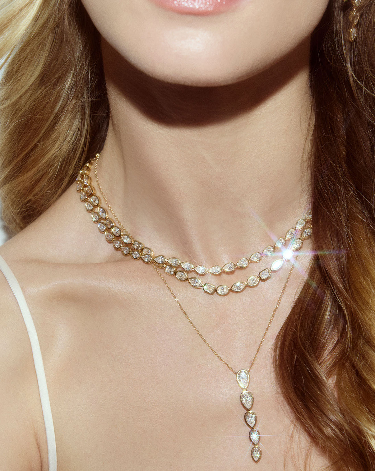 Detailed view of mixed-shapes lab diamond 14k gold tennis necklace being worn on neck