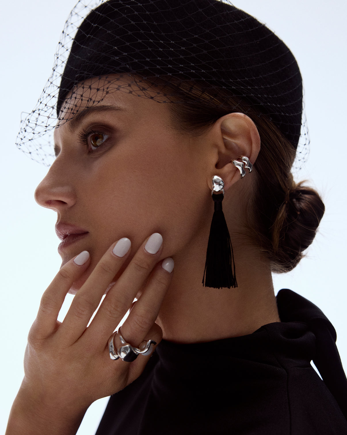 Coco Tassel Earrings worn on model showing how the gold chain tassels elegantly frame the face