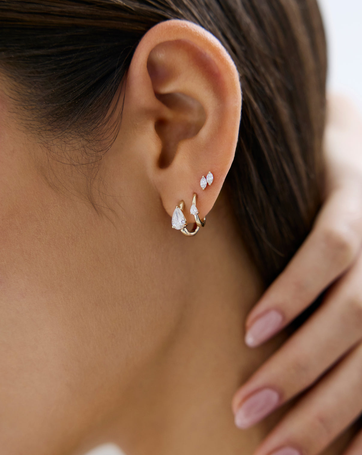 Woman wearing Ring Concierge Double Marquise Studs from the Holiday Collection - luxurious diamond earrings styled for holiday celebrations