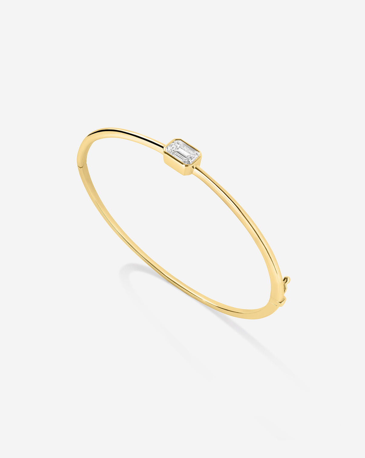 Ring Concierge Holiday Collection emerald bangle close-up showing detailed emerald stone setting and gold craftsmanship