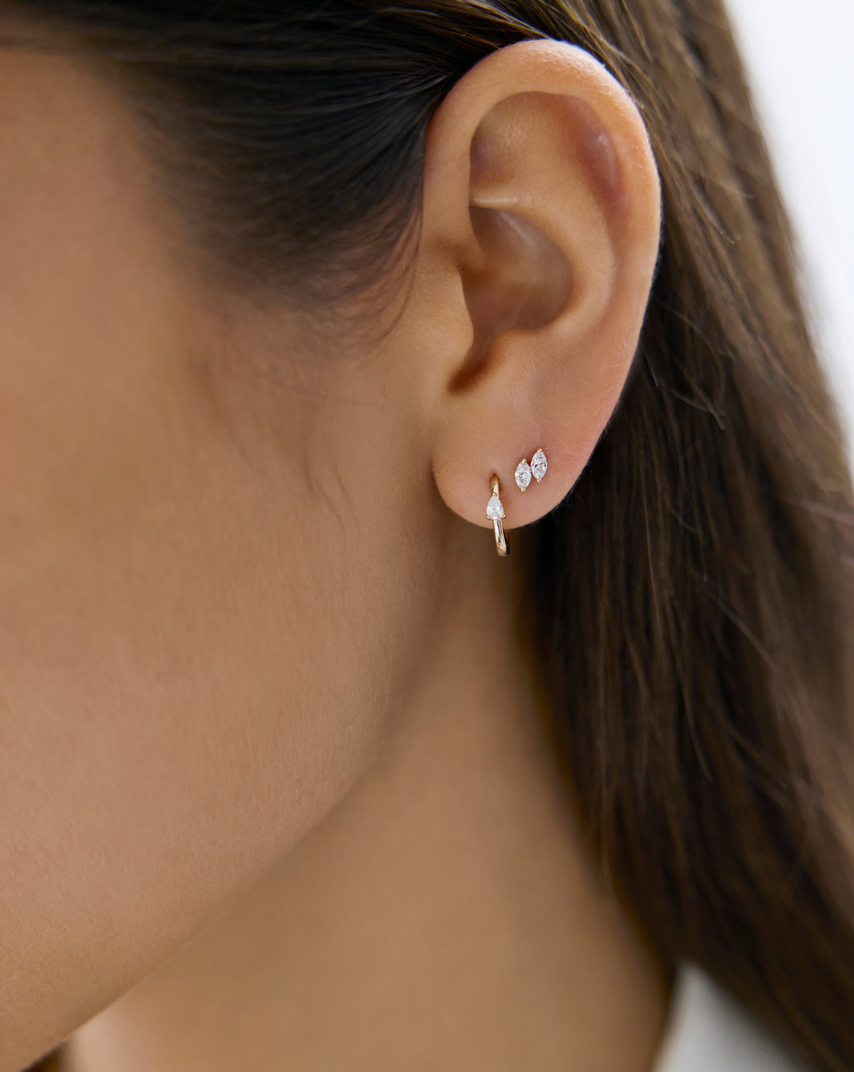 Mini Pear Huggies by Ring Concierge - Holiday Gifting Collection detail shot showing pear diamond setting