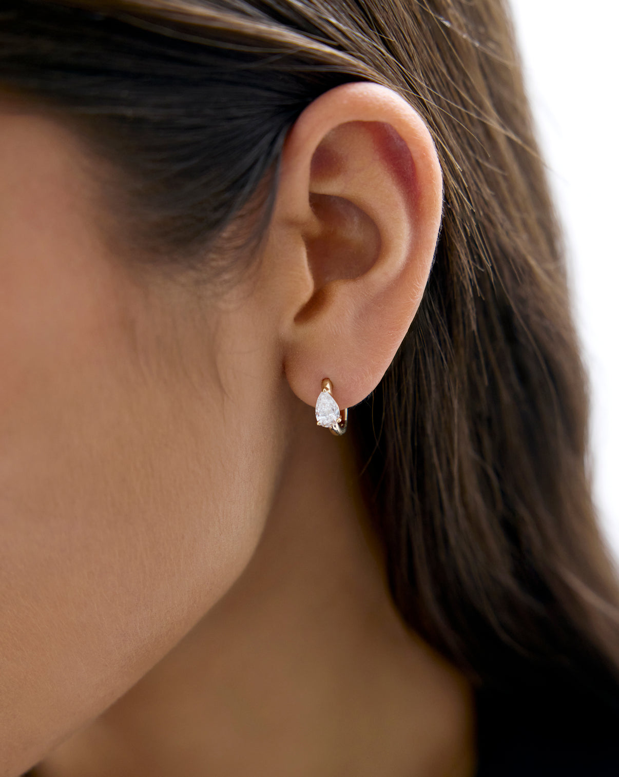 Pear Huggies by Ring Concierge Holiday Gifting Collection - Lifestyle shot of gold and diamond hoop earrings