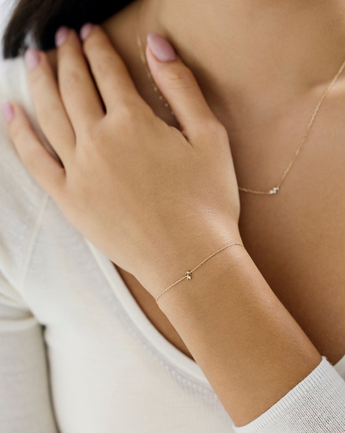 Ring Concierge Zodiac Bracelet Holiday Collection - Lifestyle shot showing gold zodiac charm bracelet worn on wrist, perfect gift for astrology lovers