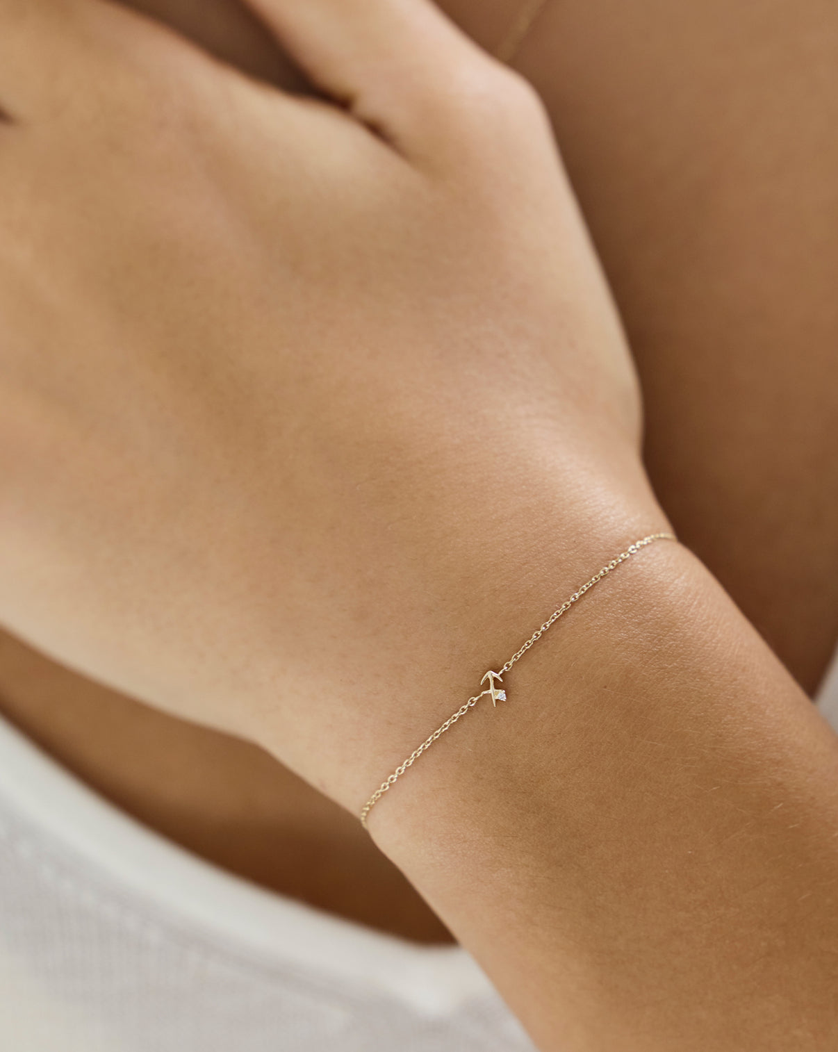 Ring Concierge Zodiac Bracelet Holiday Gifting - Model wearing delicate gold zodiac bracelet, elegant everyday fine jewelry piece