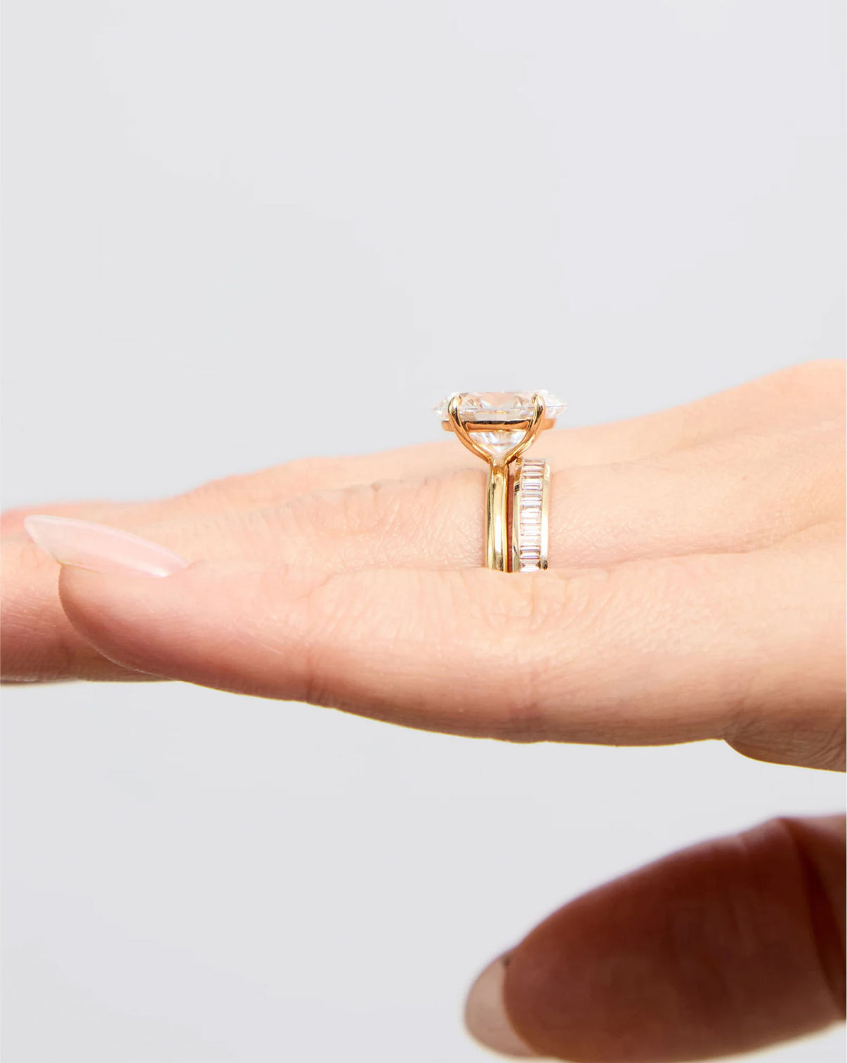 side view of Baguette Diamond Channel Set Band in 14K Yellow Gold stacked with an engagement ring