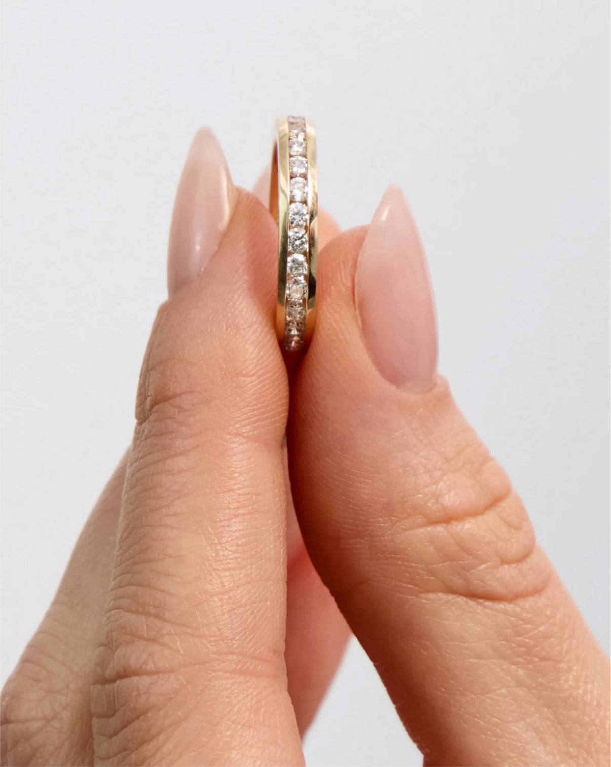 close up of Round Diamond Channel Set Band ring in 14K Yellow Gold
