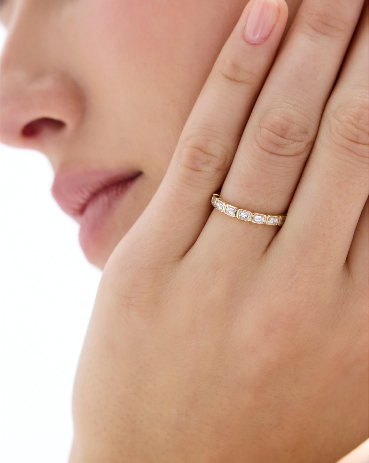 Model wearing Sideways Emerald Bezel Eternity Band in gold global