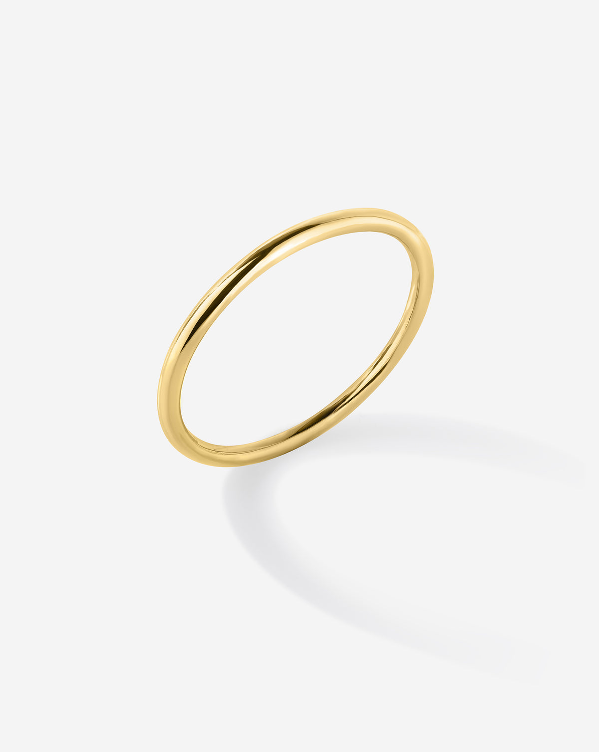 Angled view of the 14k Solid Yellow Gold Petite Stackable Ring. 14k Yellow Gold 