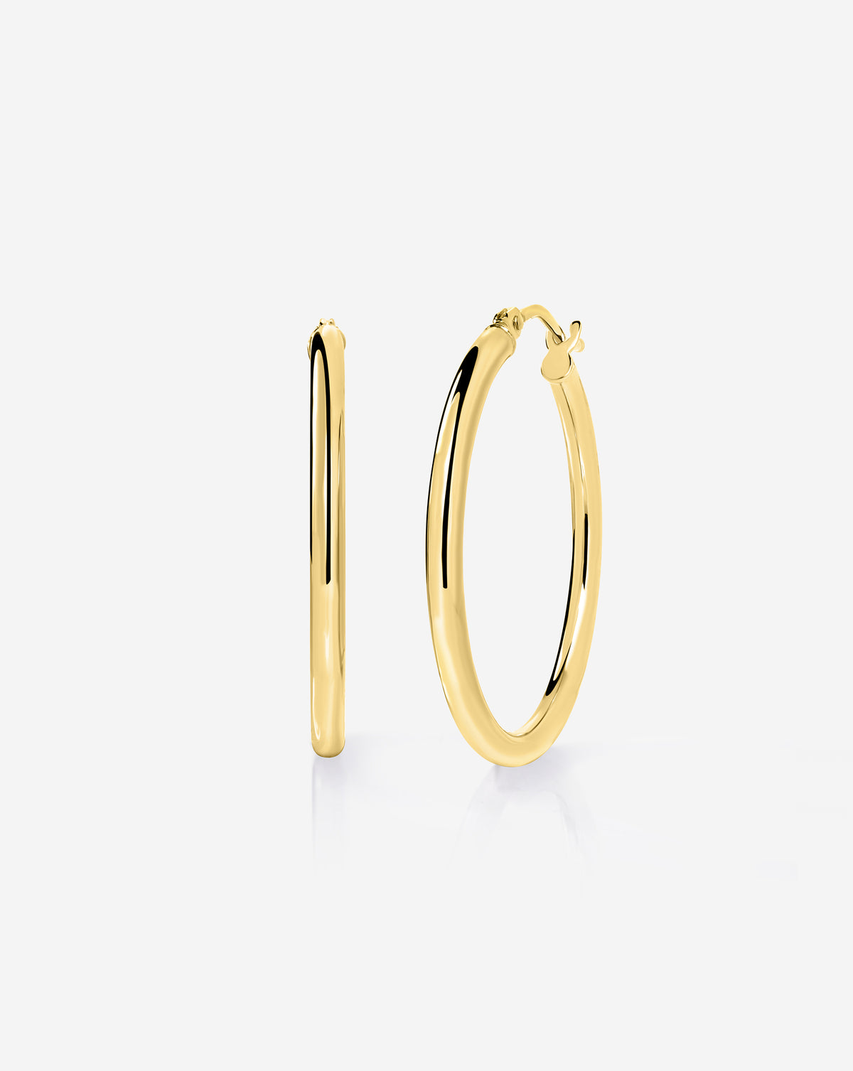 14k yellow gold essential medium hoop earrings with a classic rounded design and hinged closure, displayed on a white background.