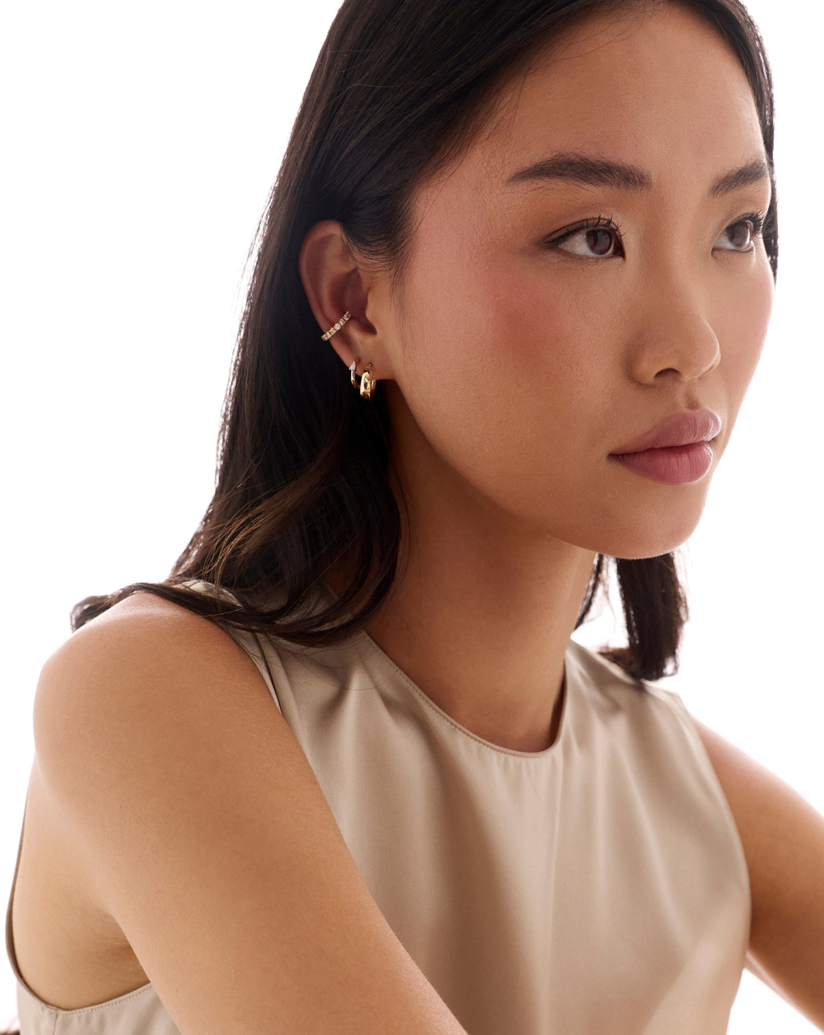 global wide mini hoop earrings worn on the ear, styled with a delicate pavé ear cuff. 