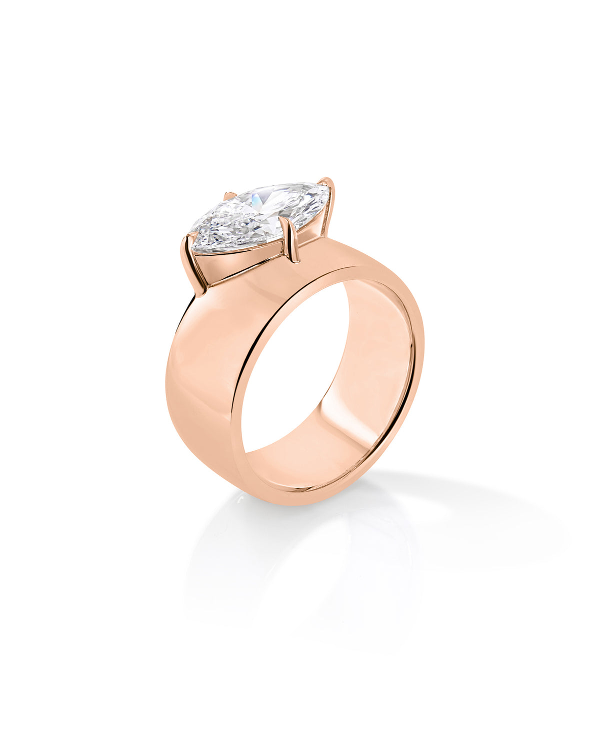 Angled side view of The Eclipse ring with a marquise-cut diamond in a raised setting on a wide 14K rose gold half-dome band. 67586638807128