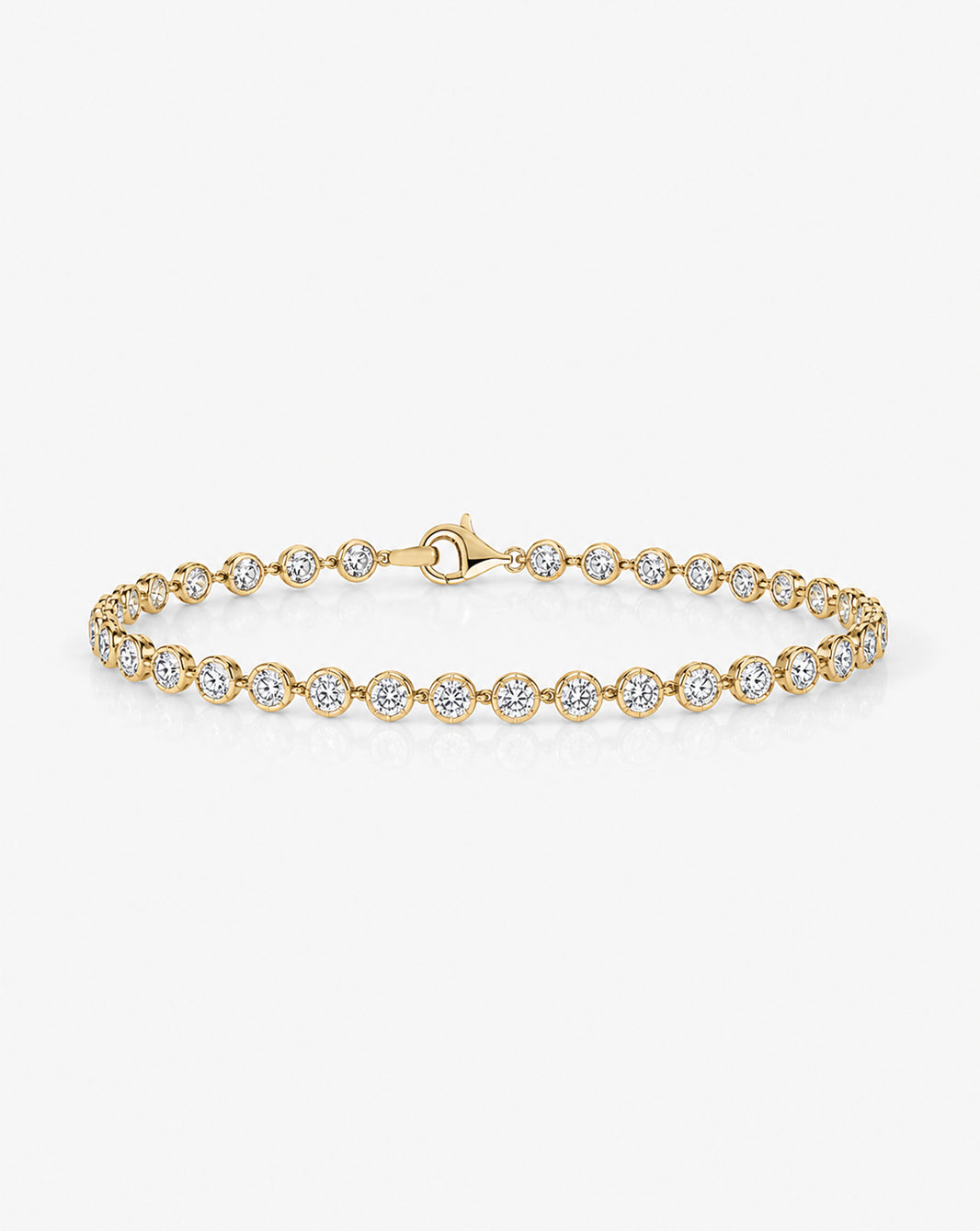 Gold tennis bracelet with round-cut clear stones in gold settings and a lobster clasp, displayed on a white background. 44299697225816, 44299697586264