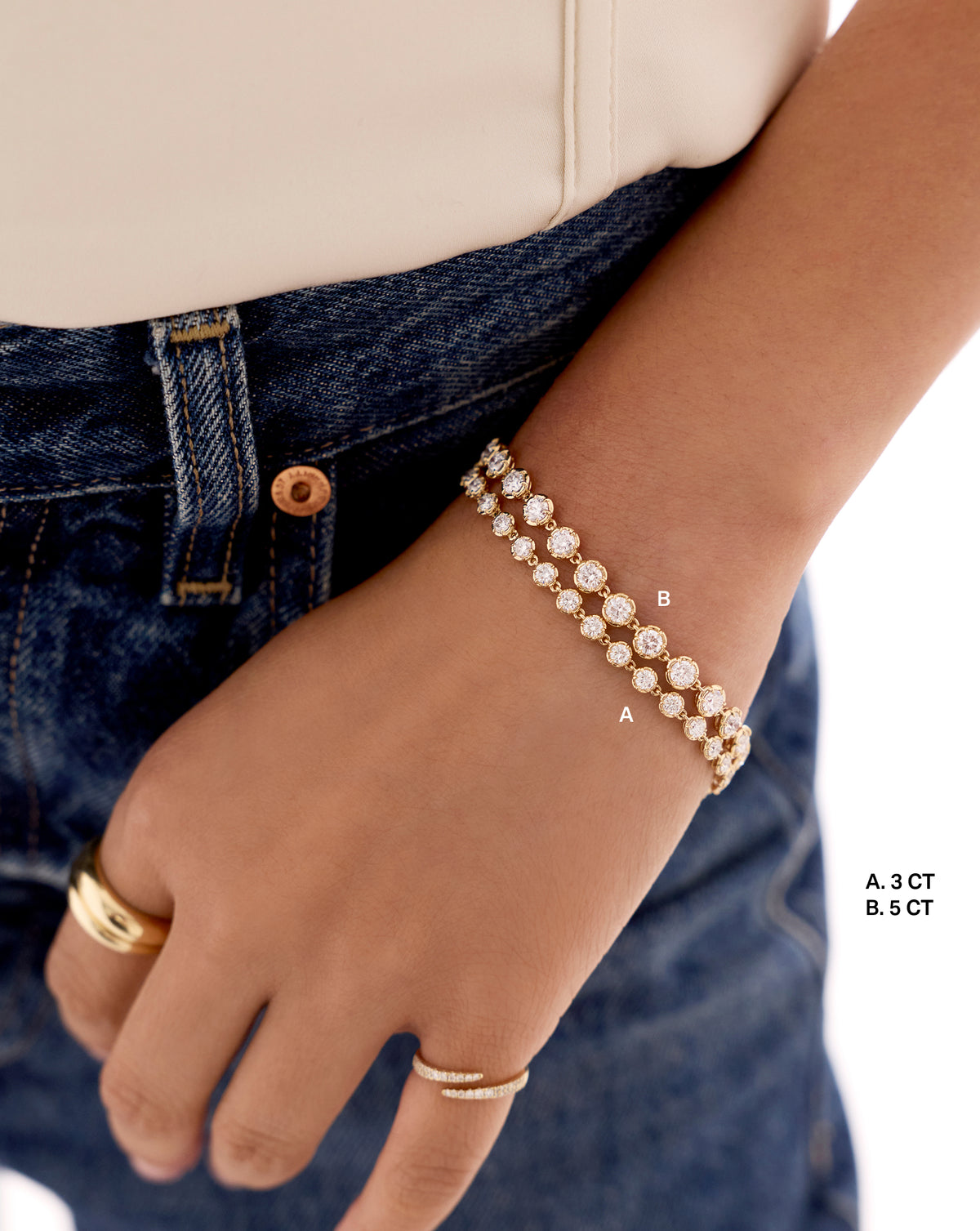 3 and 5 carat, Gold tennis bracelet with round-cut stones worn on the wrist, styled with denim jeans.
5 ct 44299697979480, 44298694819928