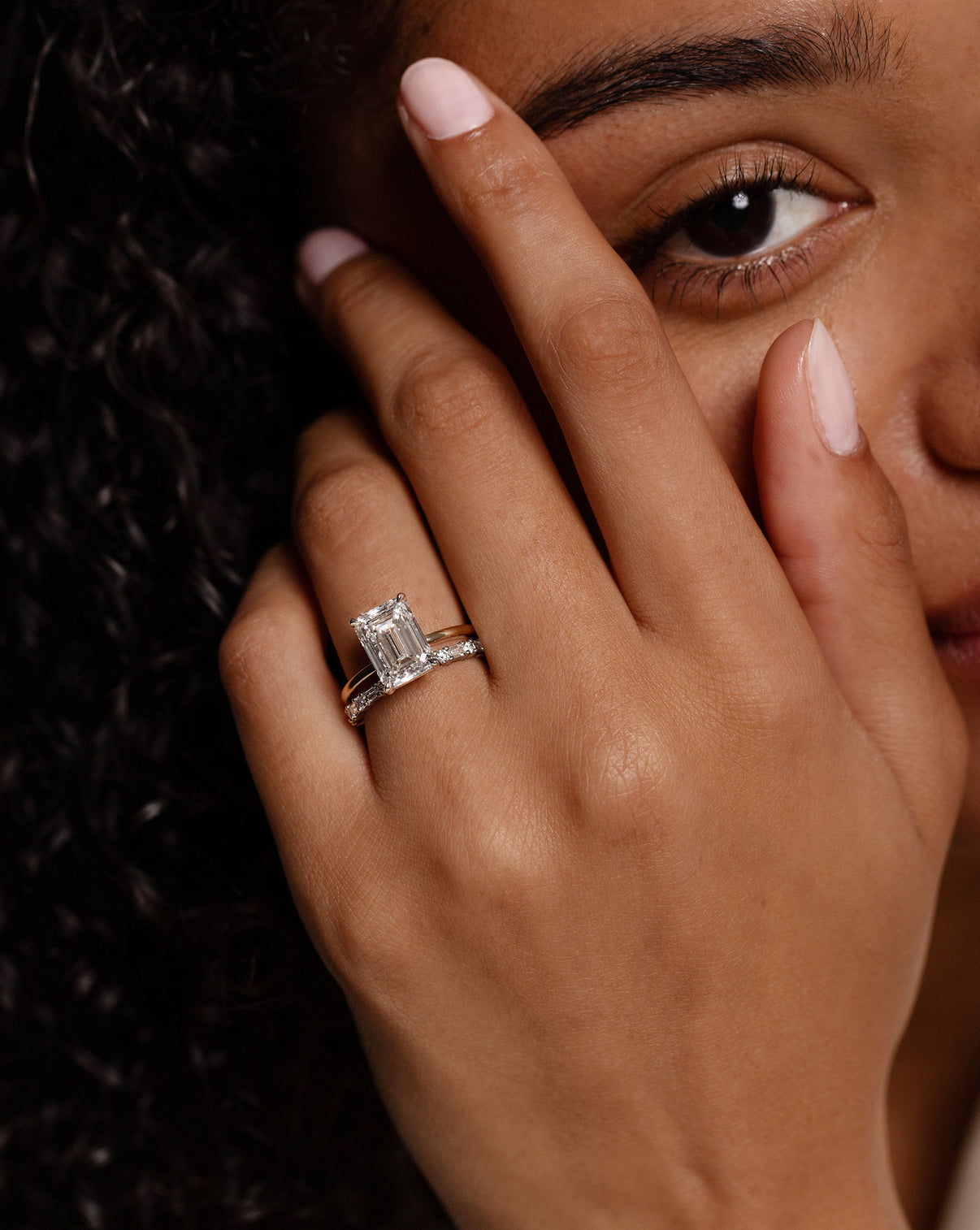 Ring Concierge Baguette + Round Eternity Band Platinum on model paired with emerald engagement ring