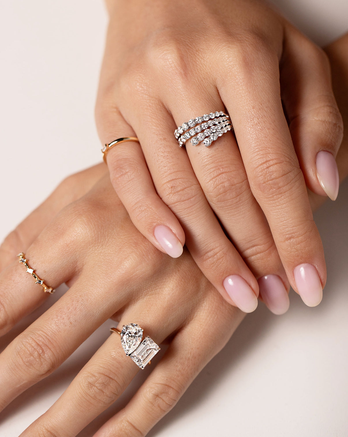 Toi et Moi engagement ring and Fanned diamond ring on model