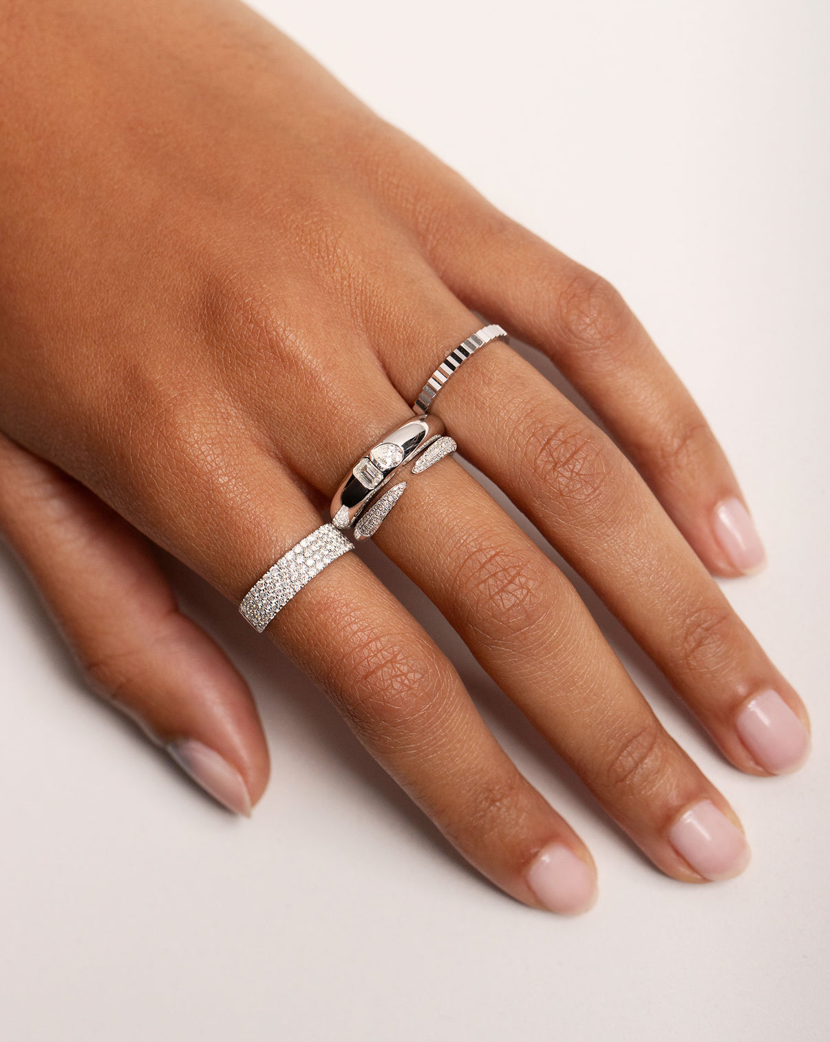model hand with 4 diamond and white gold rings
