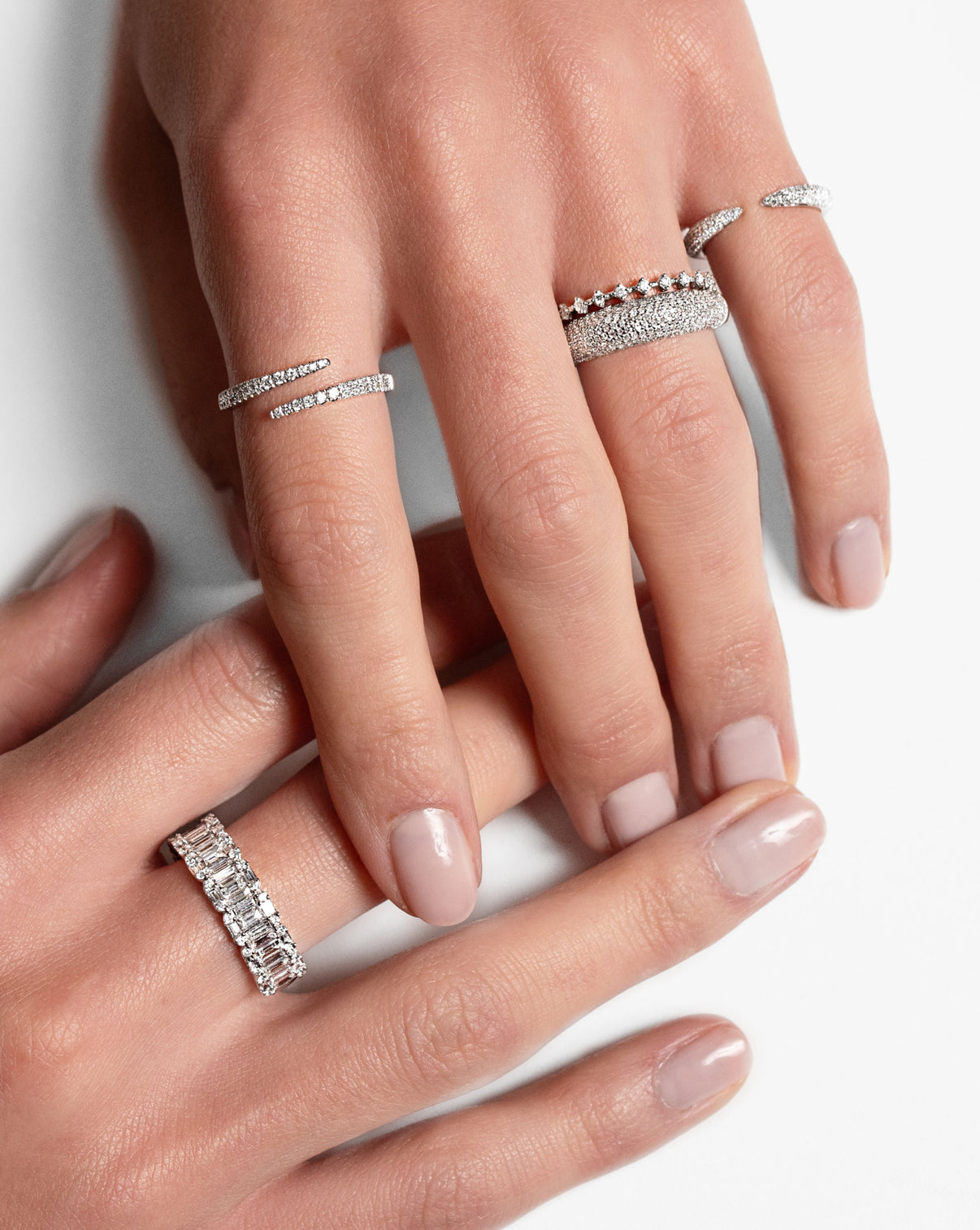 Emerald Illusion Ring, Diamond Wrap Ring, Diamond Station Ring, Pave Diamond Cloud Ring, and Pave Diamond Claw Ring in 14K White Gold on model