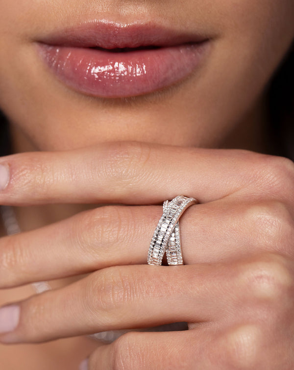 Close up image of the Petite Baguette Crossover Ring on hand of model