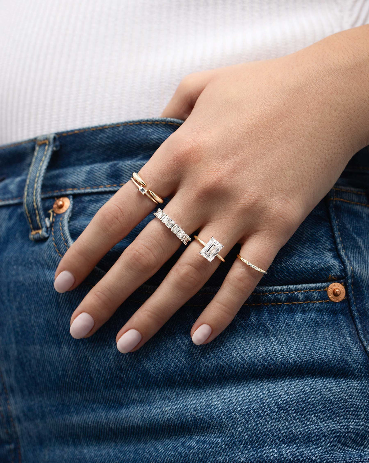 Petite Emerald Illusion Ring on middle finger on model styled with other rings