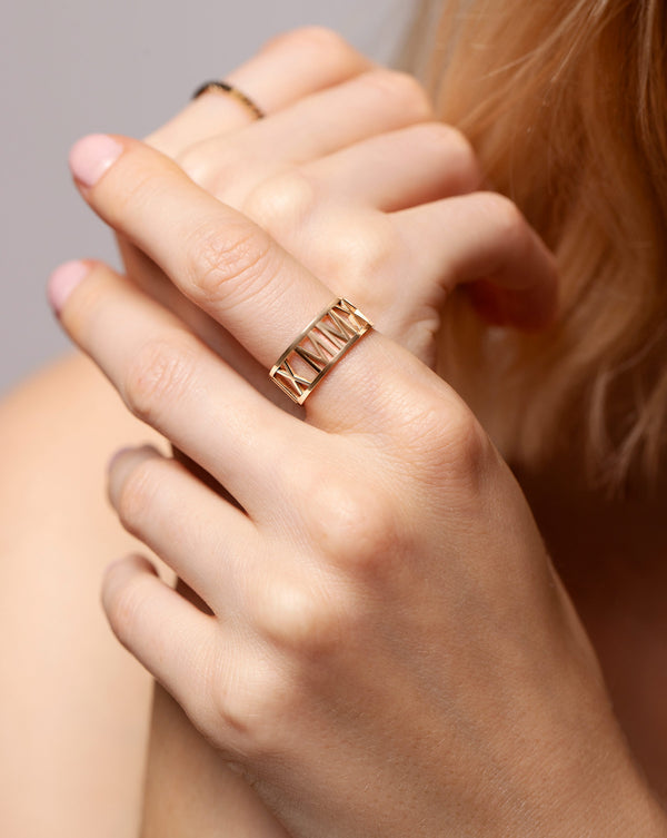Roman Numeral Personalized Ring shown on pointer finger of model