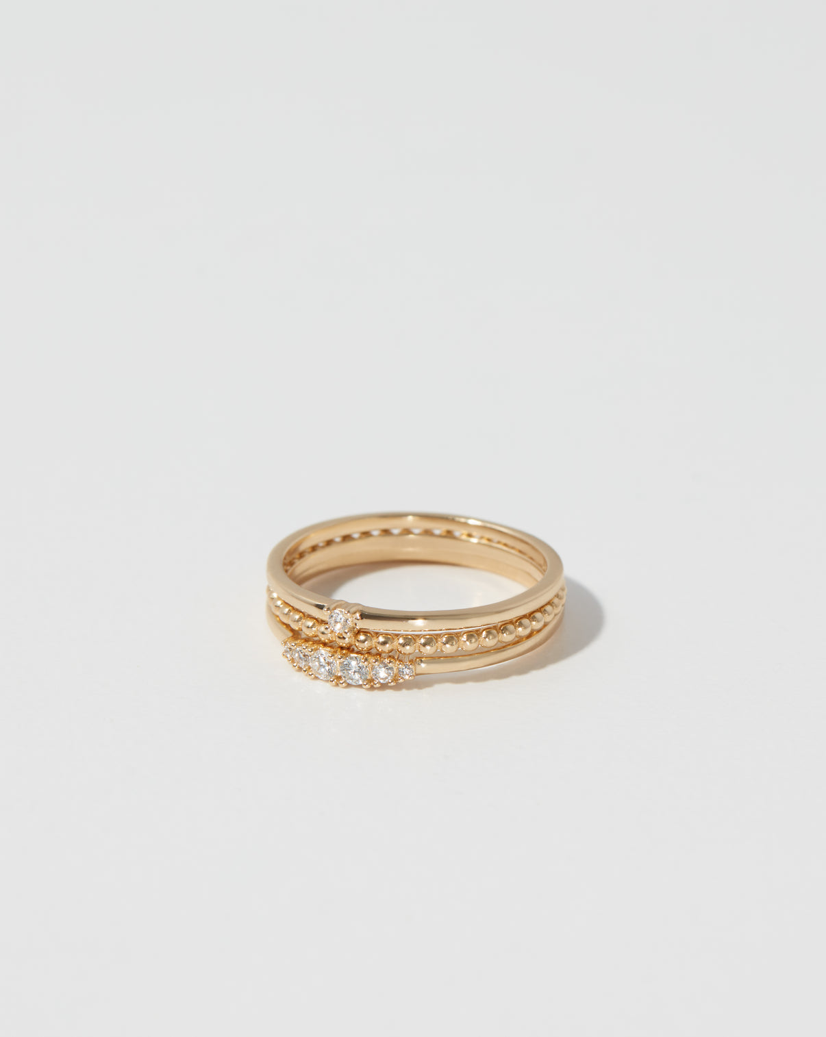 3 gold rings stacked on top of each other on white background