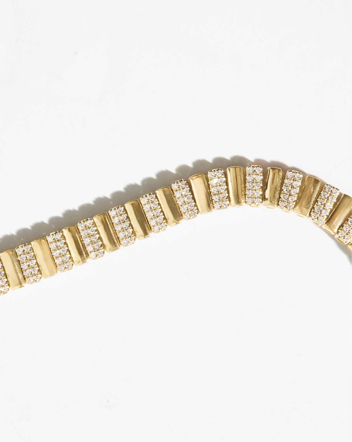 Ribbed style necklace with diamonds still image flat lay up-close