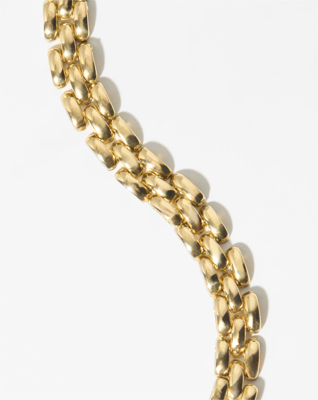 still life image of chain bracelet in yellow gold
