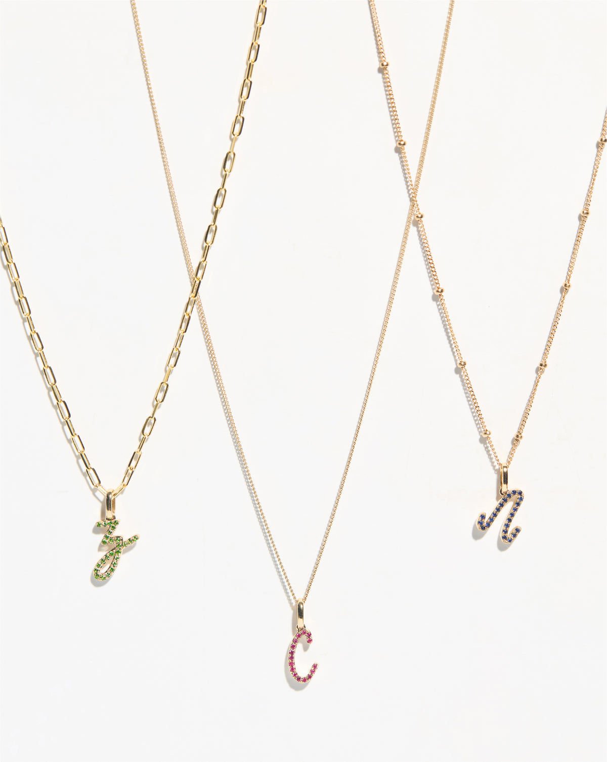 Gemstone Script Initial Pendants letters Z, C and N styled on chain options on white background