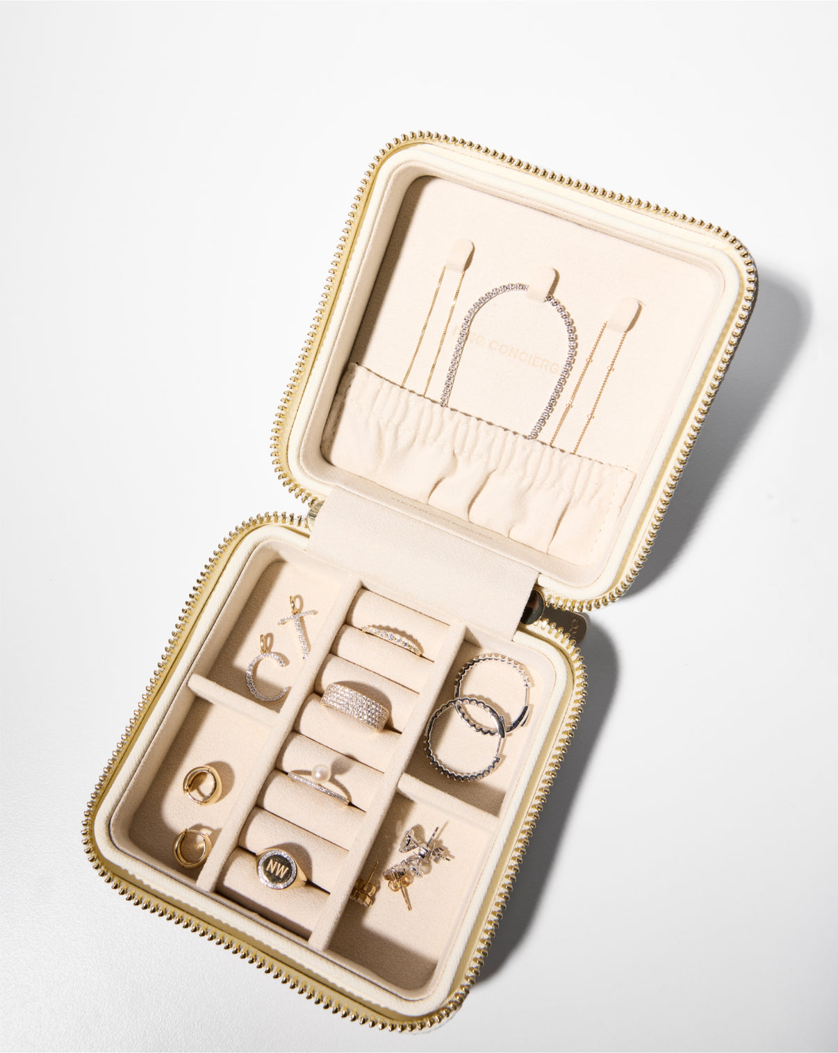 Mini Leather Jewelry Case in cream with products styled in compartments