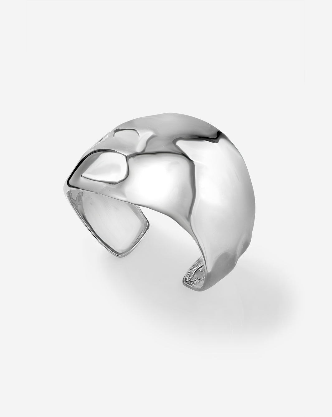 Side view of sterling silver hammered bangle bracelet displaying curved silhouette and hammered texture detail