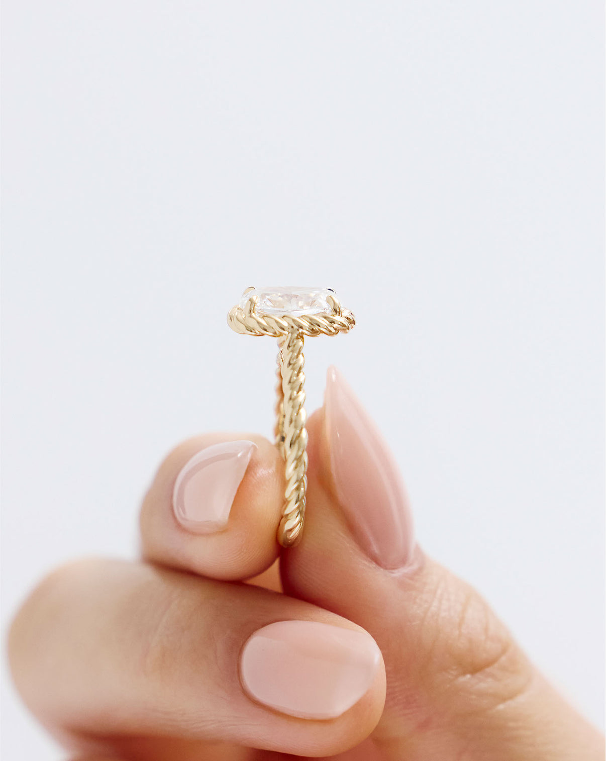 close up side view of 3 carat Round Diamond Engagement Ring in Yellow Gold Twisted Wrap