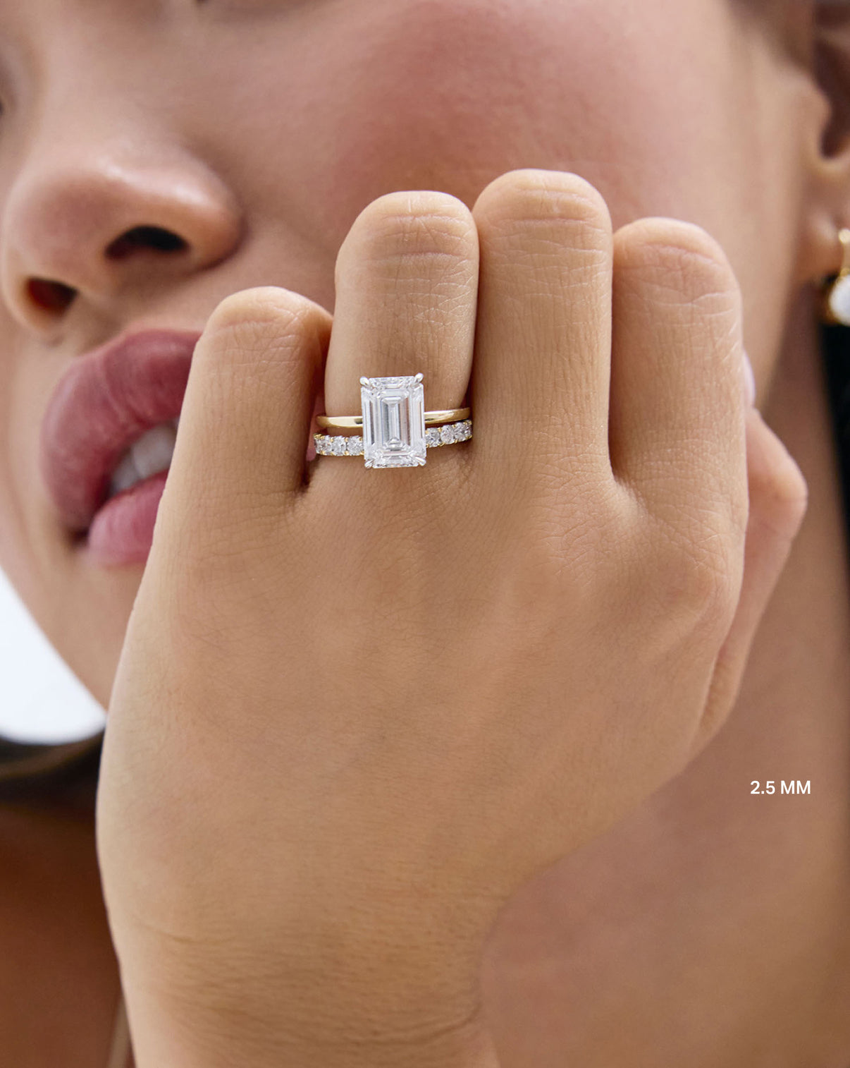 Model wearing 2.5 mm Diamond Ring with emerald engagement ring GLOBAL