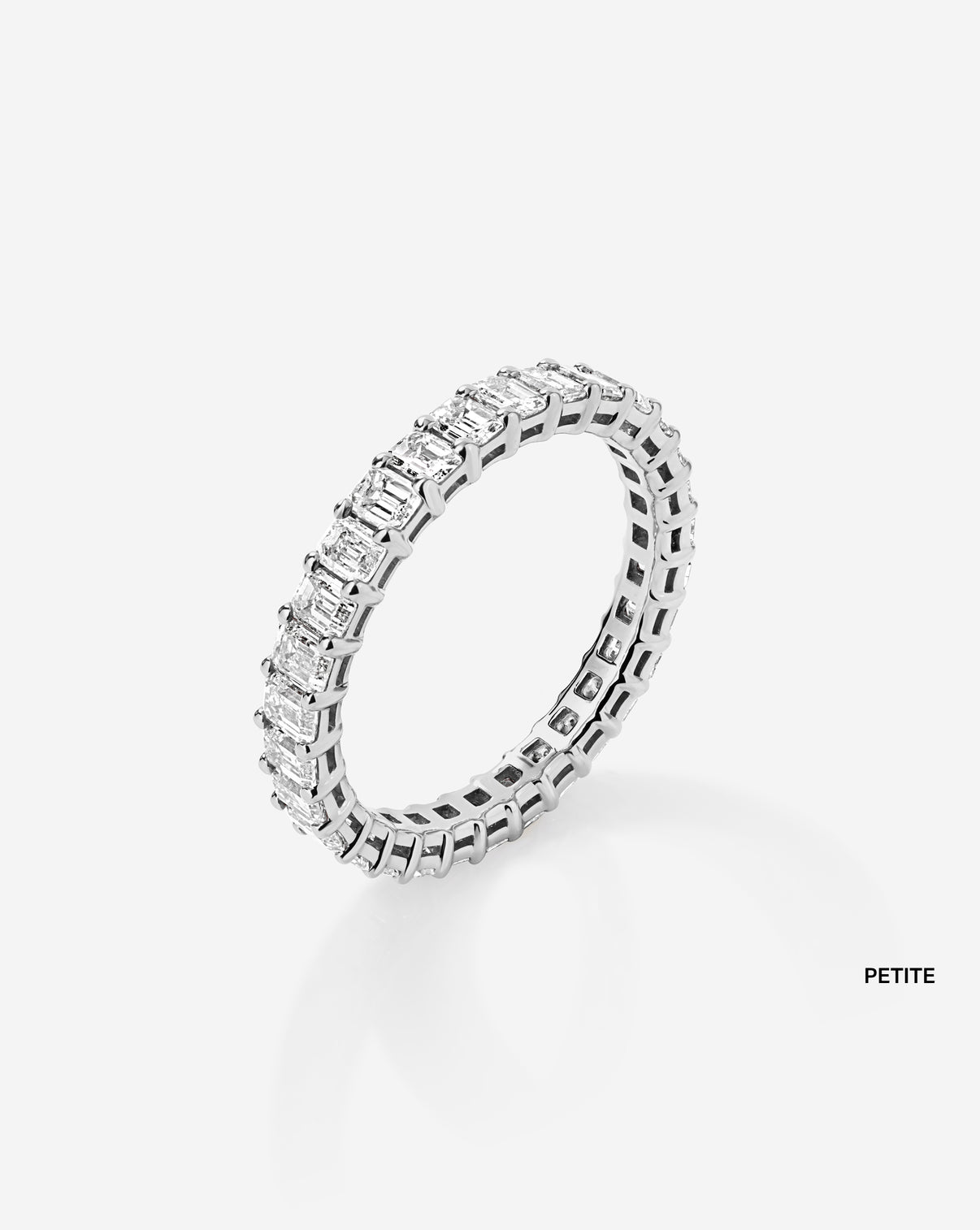 petite wedding band against white background side view platinum