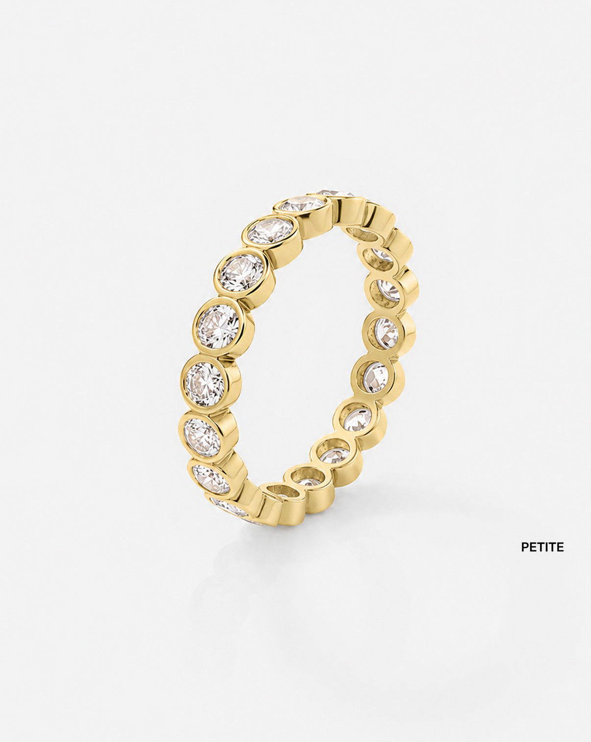 petite oval bezel on white background 14k yellow gold side view