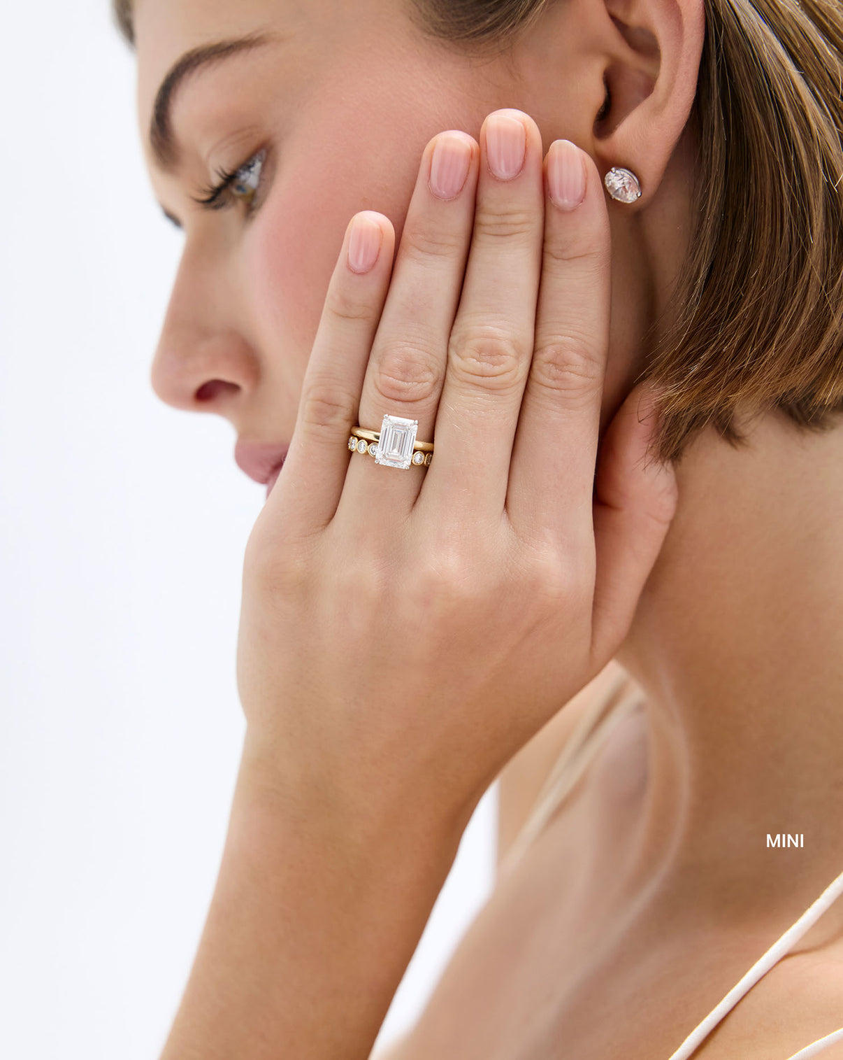3/4 round bezel lab diamond wedding band mini on model yellow gold with engagement ring global