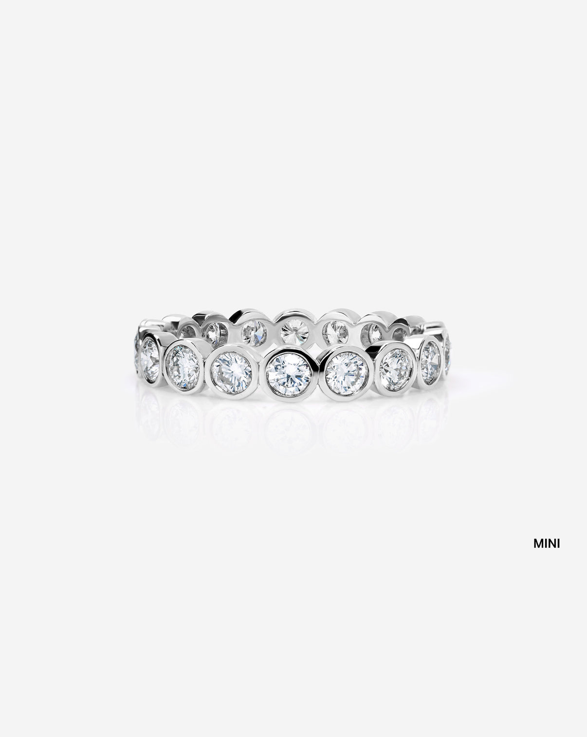 mini round bezel wedding band on white background platinum