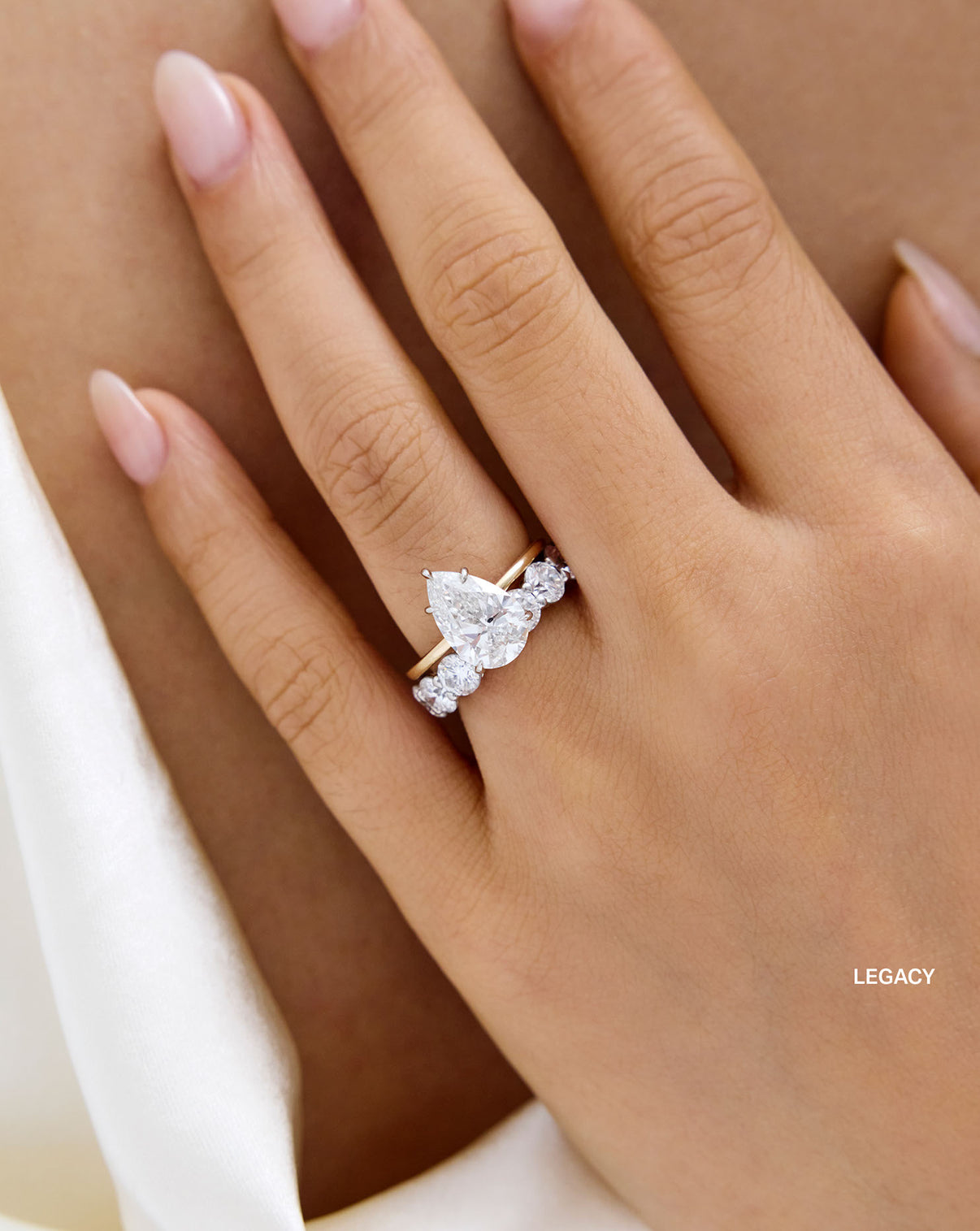 Round 3/4 Lab Diamond Band Legacy size shown styled with a pear engagement ring on model global