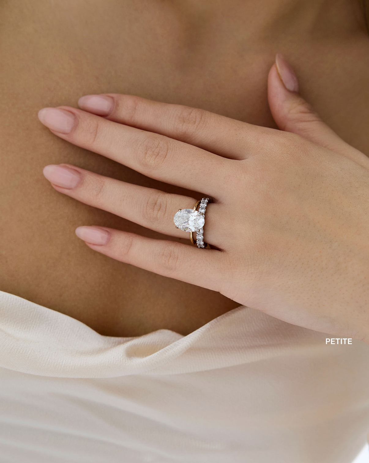 Round 3/4 Diamond Band shown styled with an oval engagement ring on model global