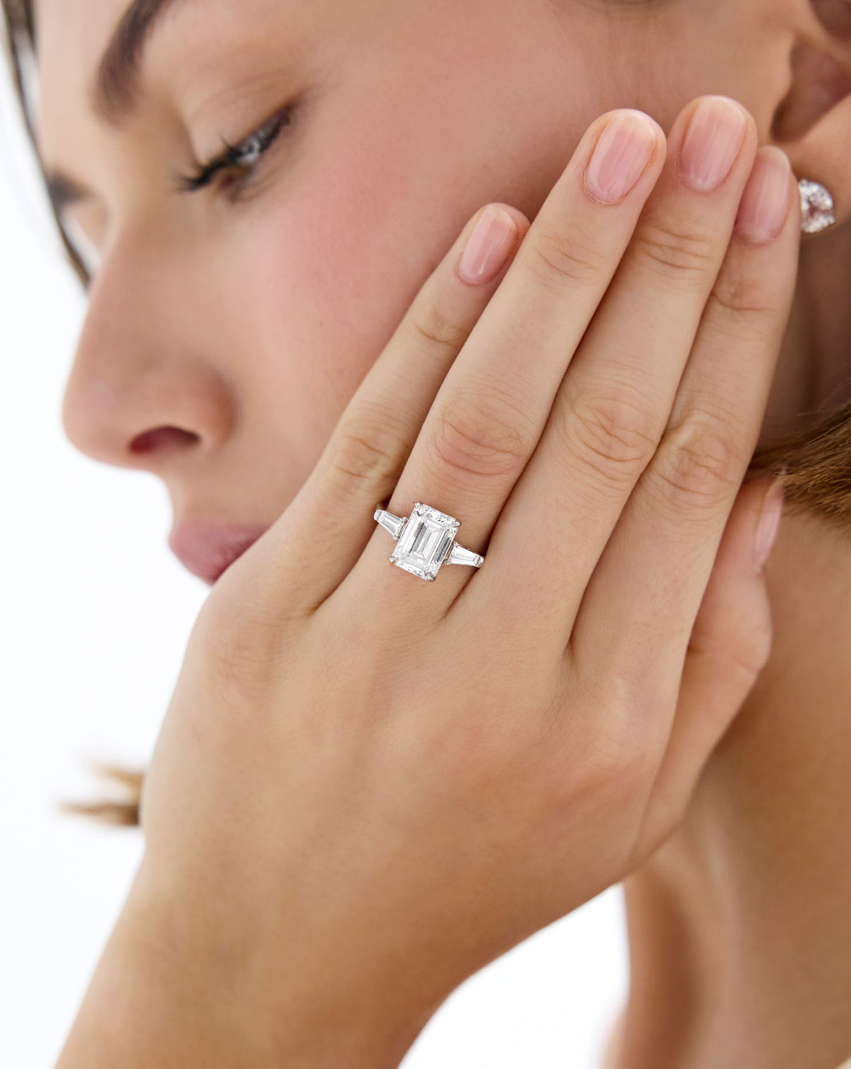 Emerald Diamond in Whisper Thin® Three Stone with Tapered Baguettes Platinum shown on model's hand
