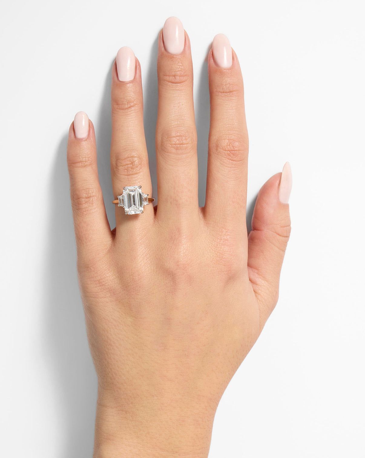 Ring Concierge Engagement Rings 3 carat Emerald in Yellow Gold Whisper Thin with trapezoid side stones shown on model's hand