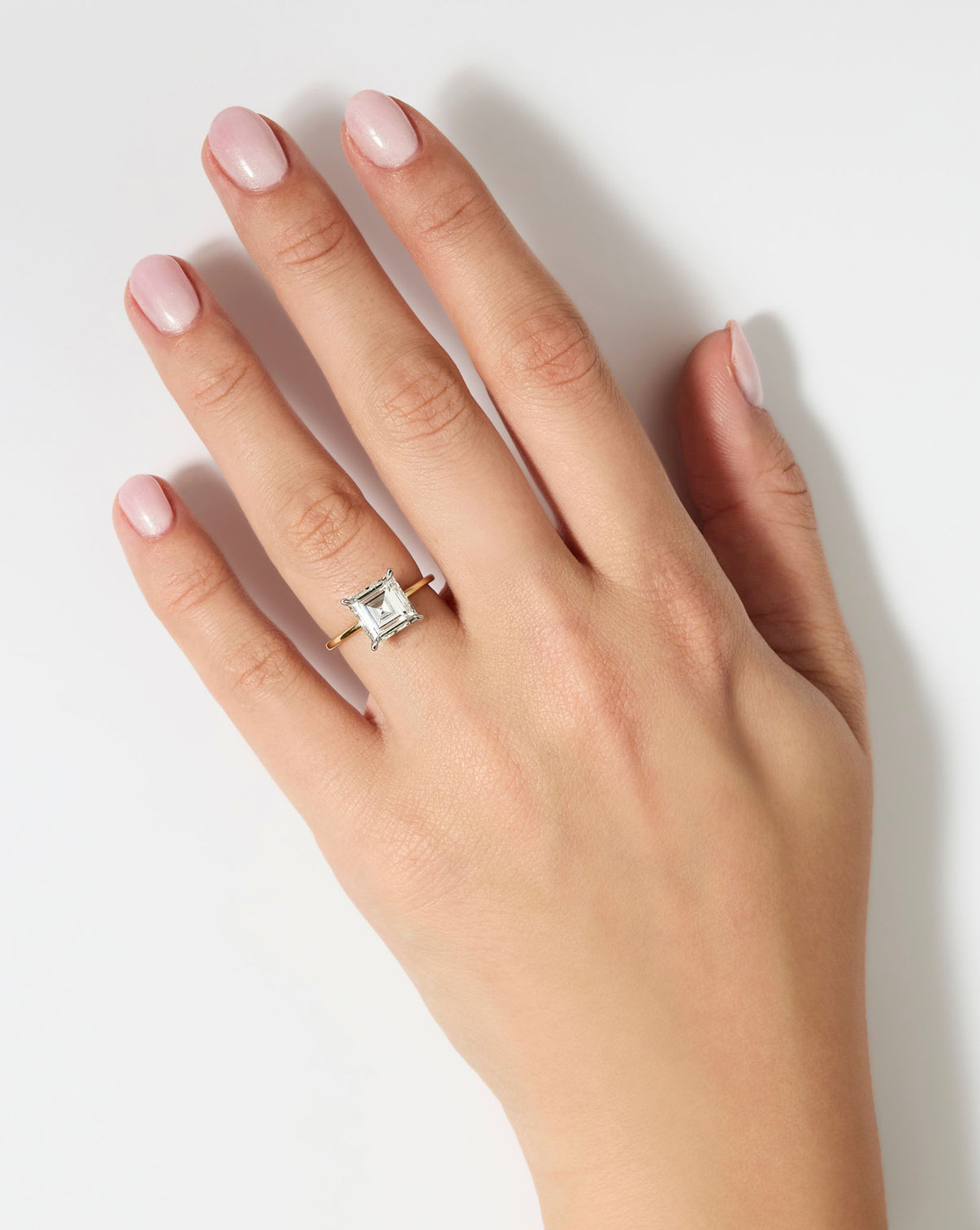 3 carat Asscher cut diamond engagement ring with Yellow Gold Whisper Thin band and Platinum Prongs shown on model's hand